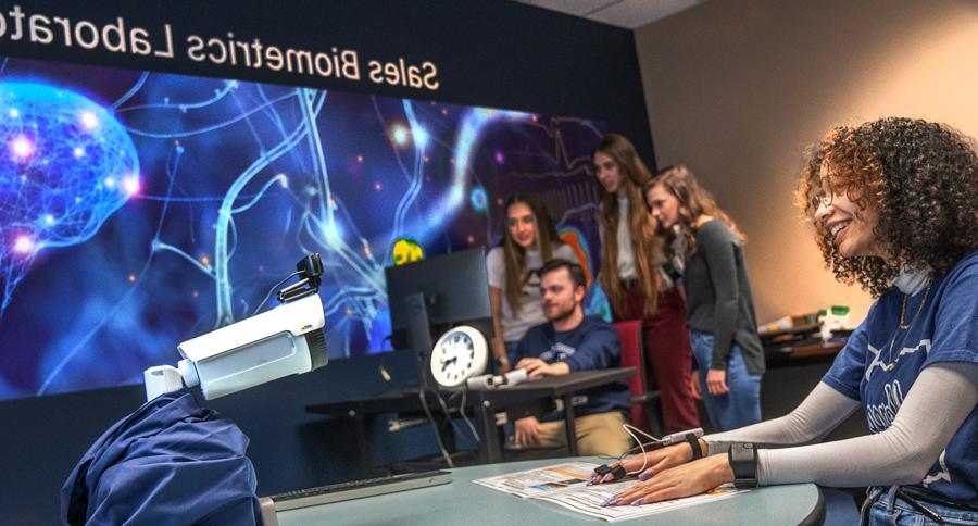 UA students conducting research in the Fisher Sales Lab in The College of Business at The University of Akron.